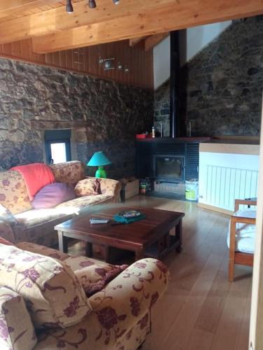 a living room with a couch and a table at La casa de Juan el Cantero in Puebla de Lillo