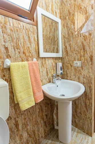a bathroom with a sink and a mirror at Hotel Olti in Vlorë