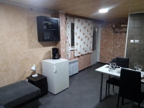 a small living room with a refrigerator and a table at Apartment by the park in Imatra