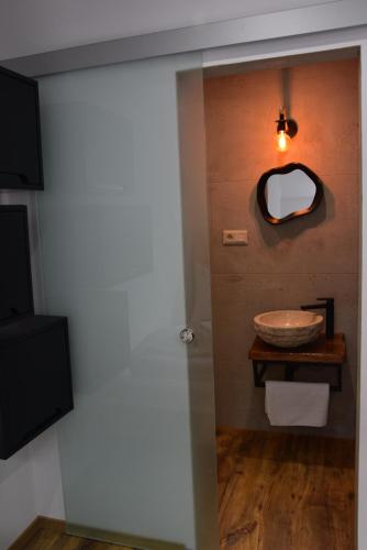 a bathroom with a sink and a mirror on the wall at Apartmány Žakovce & SPA in Veľká Lomnica