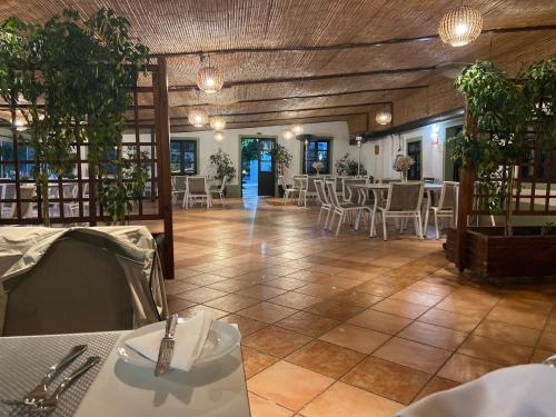a dining room with tables and chairs in a building at Studio Pedras del Rei - Casa Verde in Tavira