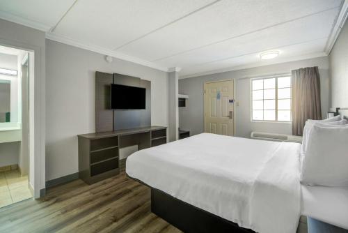 a hotel room with a large bed and a television at Motel 6 San Antonio, TX I-35 North Corridor in San Antonio