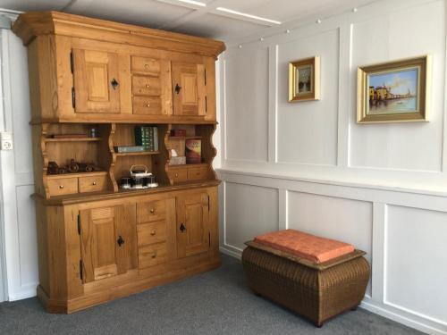 a kitchen with wooden cabinets and a stool in a room at Ursprungshaus - Nuss und Traube in Dornbirn