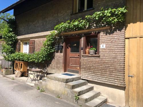 a building with a door and stairs in front of it at Ursprungshaus - Nuss und Traube in Dornbirn