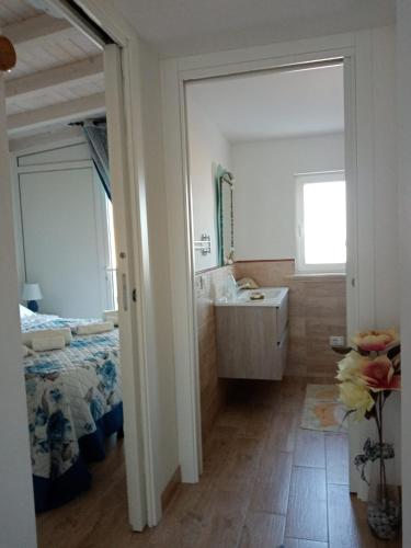 a bathroom with a sink and a bed at La Terrazza Solarium, in pieno centro 60m dalla stazione ferroviaria 700m dal mare in Santa Flavia