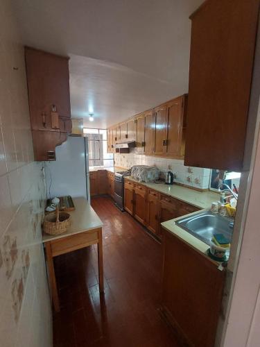 a kitchen with wooden cabinets and a counter top at maizon plaza I in Arequipa