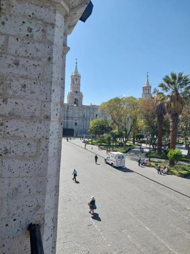 a group of people walking on a street near a building at maizon plaza I in Arequipa
