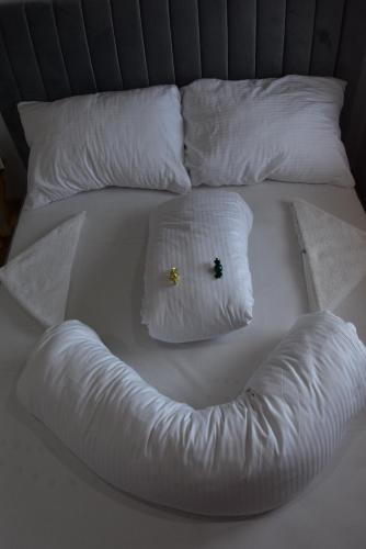 a white bed with two pillows and twongth at Apartmány Žakovce & SPA in Veľká Lomnica