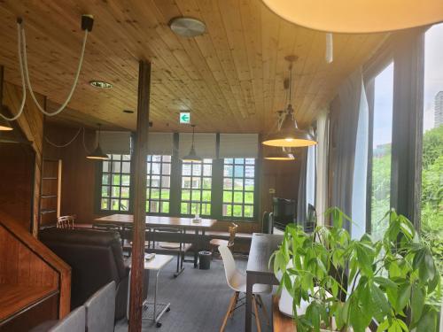 a living room with a table and a potted plant at ロッヂノエル in Seki