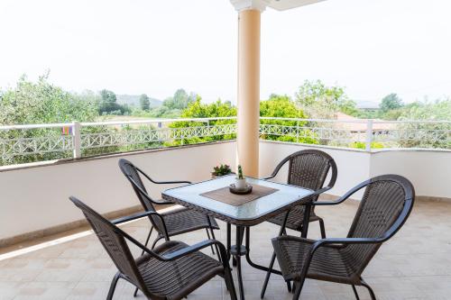 a patio with a table and chairs on a balcony at Apartments Vasileiou Suite 4 in Preveza