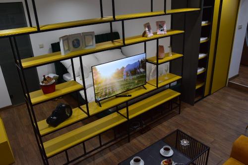 a living room with a tv on a shelf at Apartmány Žakovce & SPA in Veľká Lomnica