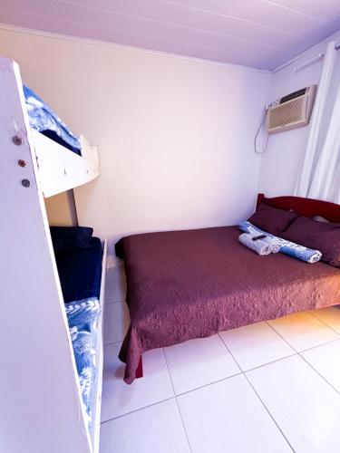 Ένα ή περισσότερα κρεβάτια σε δωμάτιο στο Pousada Suites Jacumã