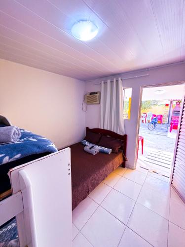 Ένα ή περισσότερα κρεβάτια σε δωμάτιο στο Pousada Suites Jacumã