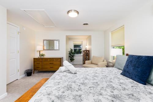a bedroom with a large bed and a living room at 5mi to Big Boulder Hot tub Patio Firepit Fast WiFi in Blakeslee