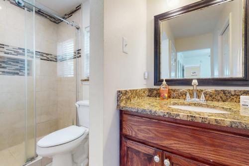 a bathroom with a sink and a toilet and a mirror at Fortuna Sea Brisas Condominiums #4 in Corpus Christi
