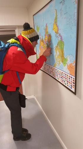 a man is looking at a map on a wall at The Lodges in Stanley
