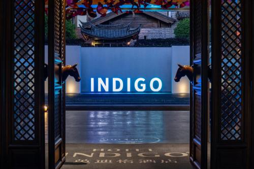 a sign with a horse on it in front of a building at Hotel Indigo Lijiang Ancient Town by IHG in Lijiang