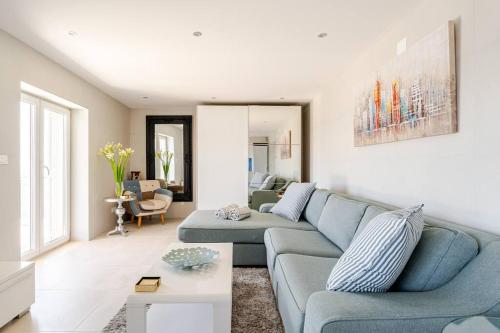 a living room with a blue couch and a table at Blue Views Villa with Heated Pool & Jacuzzi in Dubrovnik