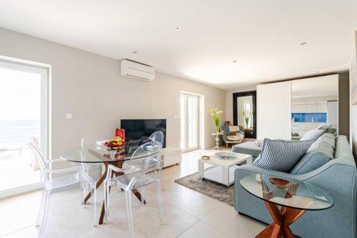 a living room with a couch and a table at Blue Views Villa with Heated Pool & Jacuzzi in Dubrovnik