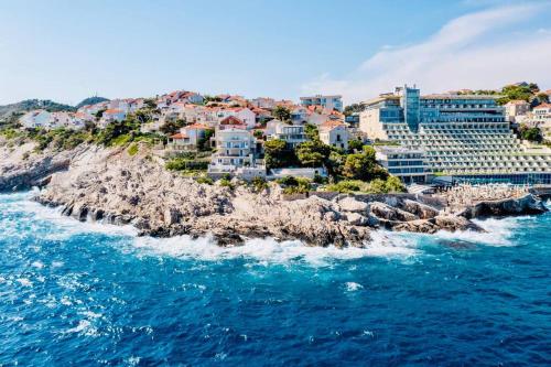 a group of buildings on a rocky island in the ocean at Blue Views Villa with Heated Pool & Jacuzzi in Dubrovnik