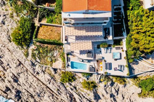 an aerial view of a house on a mountain at Blue Views Villa with Heated Pool & Jacuzzi in Dubrovnik