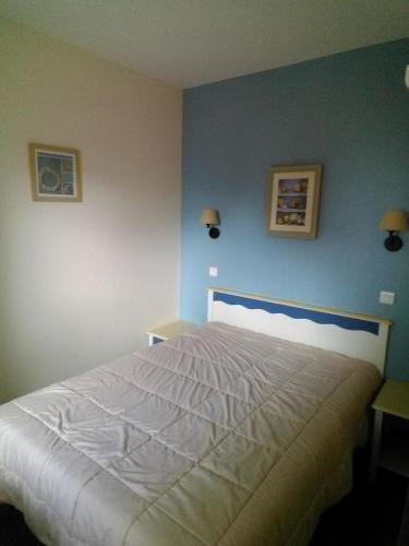 Ένα ή περισσότερα κρεβάτια σε δωμάτιο στο Appartement Les Sables Blancs