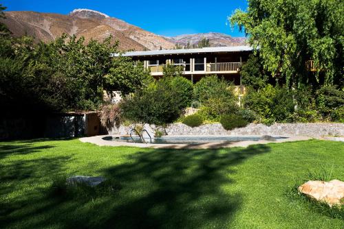 a house with a yard with grass and a building at Hotel Casona Distante in Alcoguaz