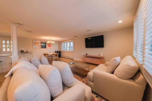a living room with a couch and a flat screen tv at Boston Luxury 3BR-Near Airport-Beach in Revere