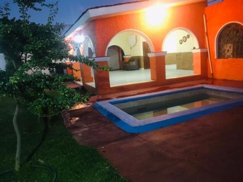 a house with a pool in the yard at night at Casa de campo tepeyac in El Salto