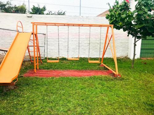 an orange swing set on the grass in a yard at Casa de campo tepeyac in El Salto