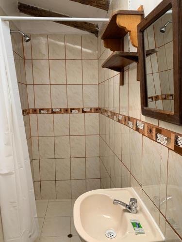 a bathroom with a sink and a mirror at Casa Patacalle in Ollantaytambo