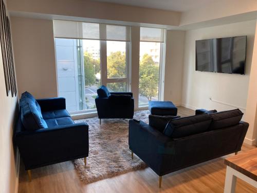 a living room with two couches and two chairs at Dapper down in West Sacramento