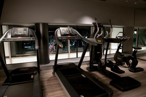a gym with two treadying machines and a city at Hotel Intergate Osaka Umeda in Osaka