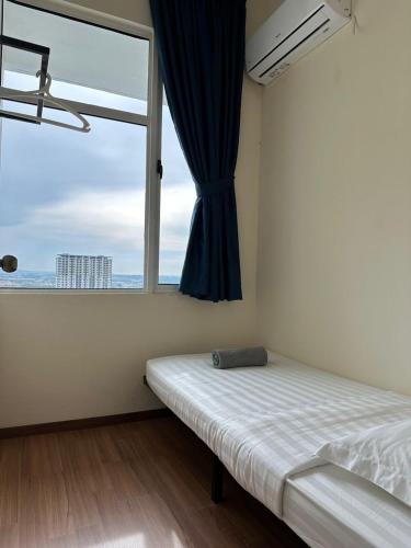 a bedroom with a bed and a large window at The Cove Homestay Sandakan - seaview in Sandakan