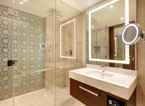 a bathroom with a sink and a shower at Crowne Plaza Dhaka Gulshan by IHG in Dhaka