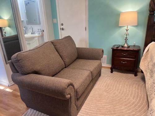 a living room with a couch and a table at Kelowna little Island near Downtown, lake, hospital and Okanagan Collage in Kelowna