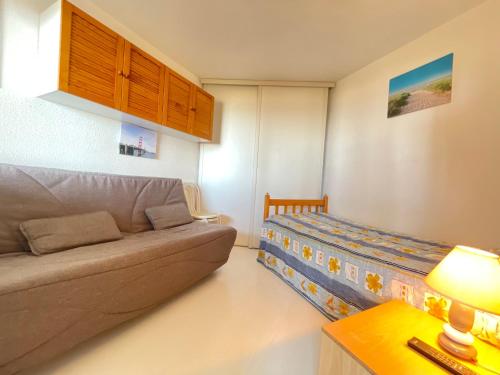 un salon avec un canapé et un lit dans l'établissement T3 à Sète: Face Mer, WIFI, Parking - FR-1-338-424, à Sète