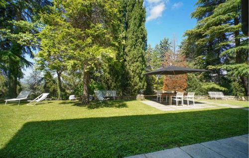 a park with a picnic table and an umbrella at Cozy Home In Marsaglia With Kitchen in Marsaglia