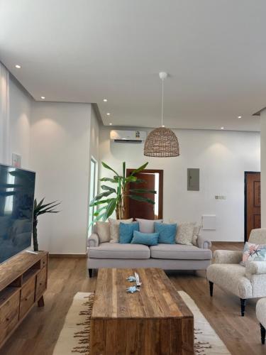 a living room with a couch and a coffee table at Sea villa sifah in Muscat