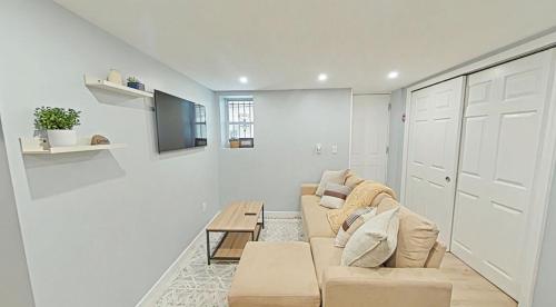 a living room with a couch and a table at One bedroom apartment with AC and WiFi in the Bronx in Williams Bridge