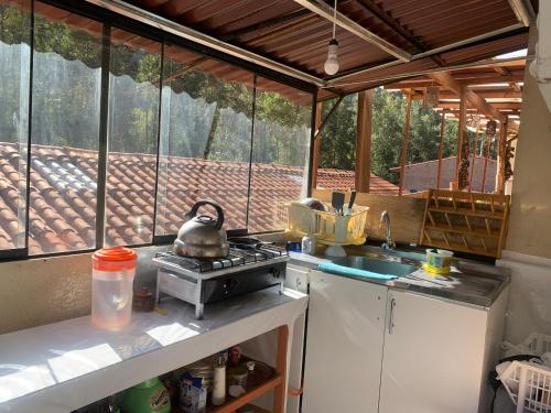 an outdoor kitchen with a stove and a sink at Casa Patacalle in Ollantaytambo