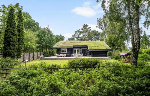a house with a green roof with a yard at Nice Home In Hornbæk With Wifi in Hornbæk