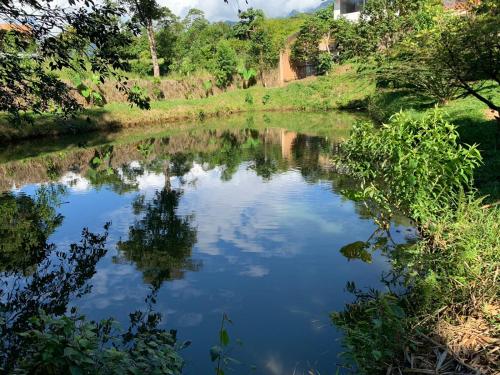 a river with a reflection of the sky in the water at Birdsong lodge in Mocoa