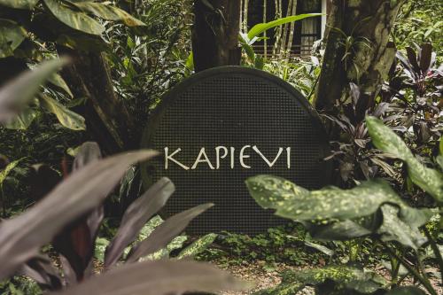 a sign that says krazyevil sitting in a garden at Kapievi Ecovillage in Puerto Maldonado