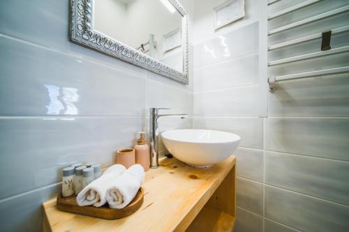 a bathroom with a white sink and a mirror at Korkyra Harbour Rooms in Korčula