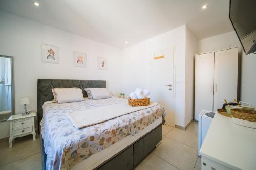 a bedroom with a large bed in a room at Korkyra Harbour Rooms in Korčula