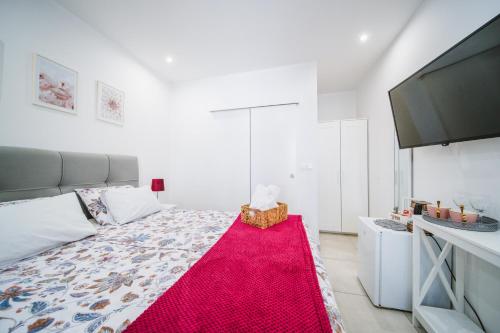 a bedroom with a large bed with a red rug at Korkyra Harbour Rooms in Korčula
