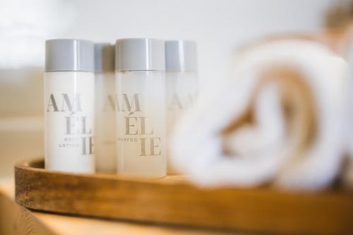 a group of three bottles of moisturizers on a shelf at Korkyra Harbour Rooms in Korčula