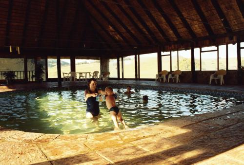 a man and a woman in a swimming pool at Elandskloof Trout Farm in Dullstroom