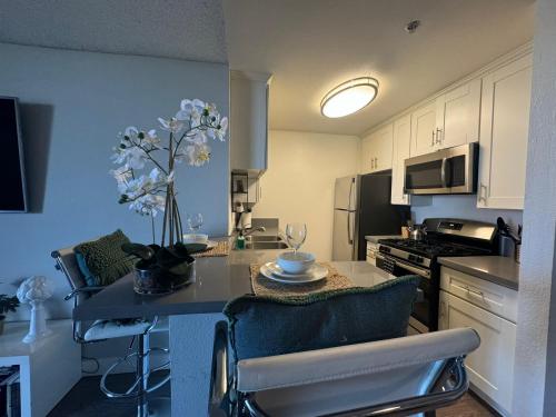 a kitchen with a table with a vase of flowers on it at Incredible Two Bedroom Hollywood Apartments FREE Parking in Los Angeles